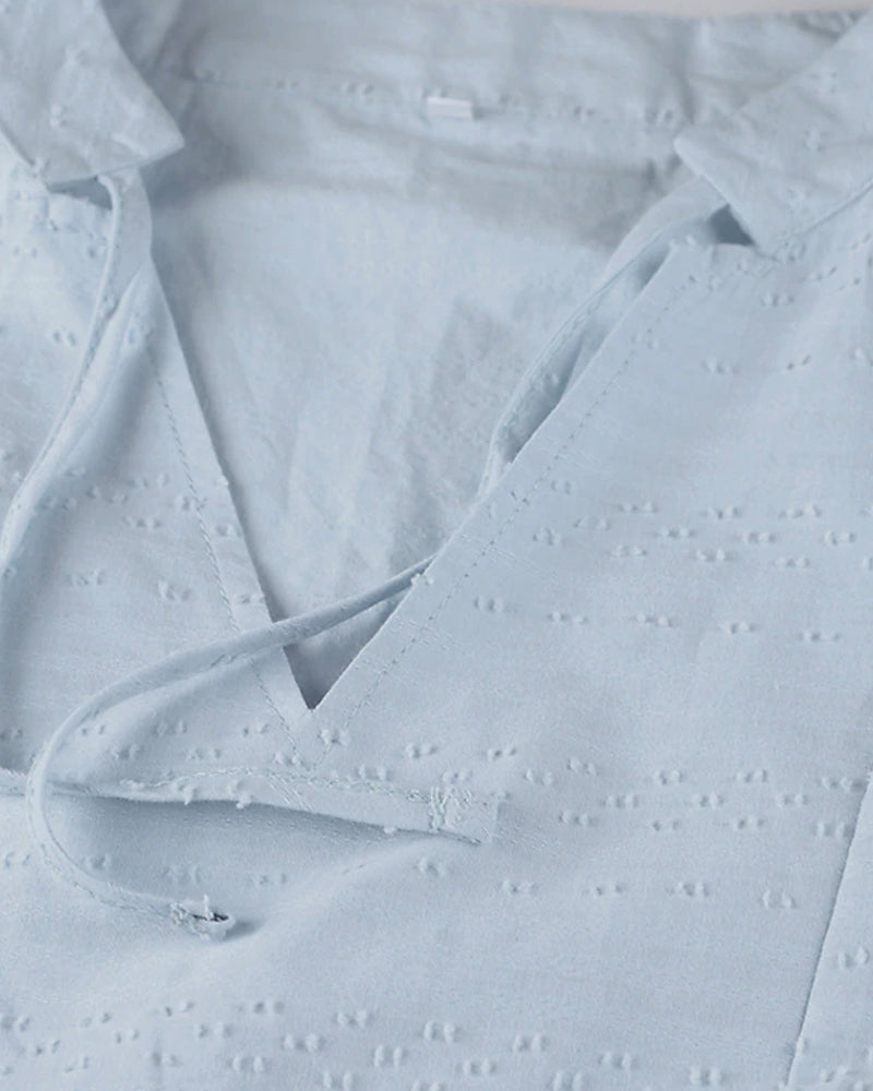 ER | Miniabito dalla linea ariosa con scollo a V, maniche a 3/4 e tasche