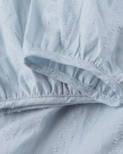 ER | Miniabito dalla linea ariosa con scollo a V, maniche a 3/4 e tasche