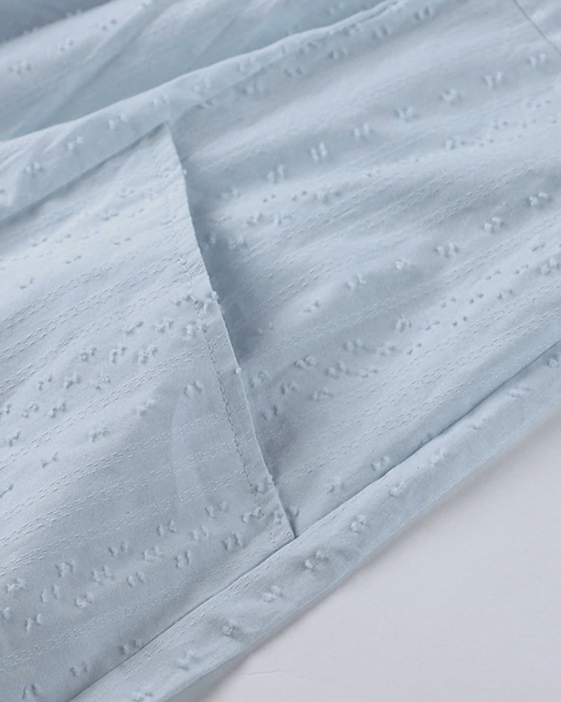 ER | Miniabito dalla linea ariosa con scollo a V, maniche a 3/4 e tasche