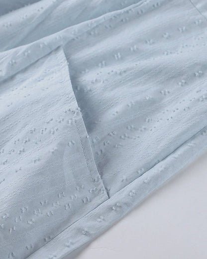 ER | Miniabito dalla linea ariosa con scollo a V, maniche a 3/4 e tasche